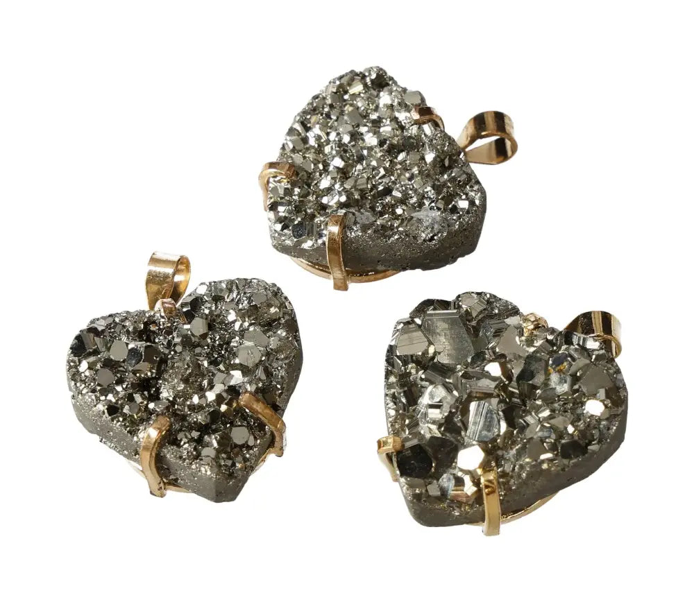 Heart-shaped pyrite claw pendants in gold with sparkling crystal texture, perfect for jewelry enthusiasts seeking elegance.