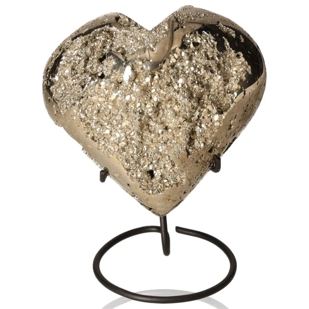 Heart-shaped pyrite stone on a stand, showcasing its golden hue and metallic luster, symbolizing abundance and prosperity.