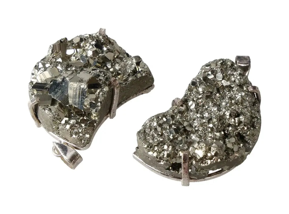 Two silver pyrite-shaped claw pendants in crescent moon design, showcasing sparkling mineral texture and intricate craftsmanship.