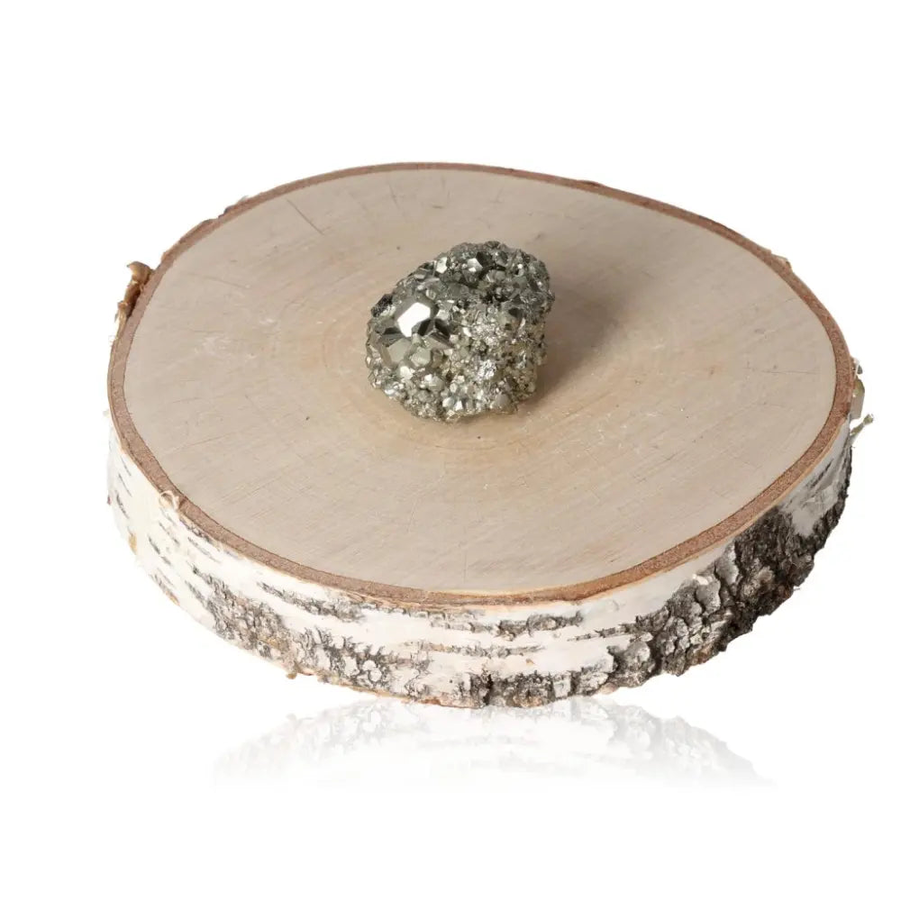 Pyrite druze mineral on natural wood slice, showcasing its golden metallic luster. Ideal for meditation or home decor.