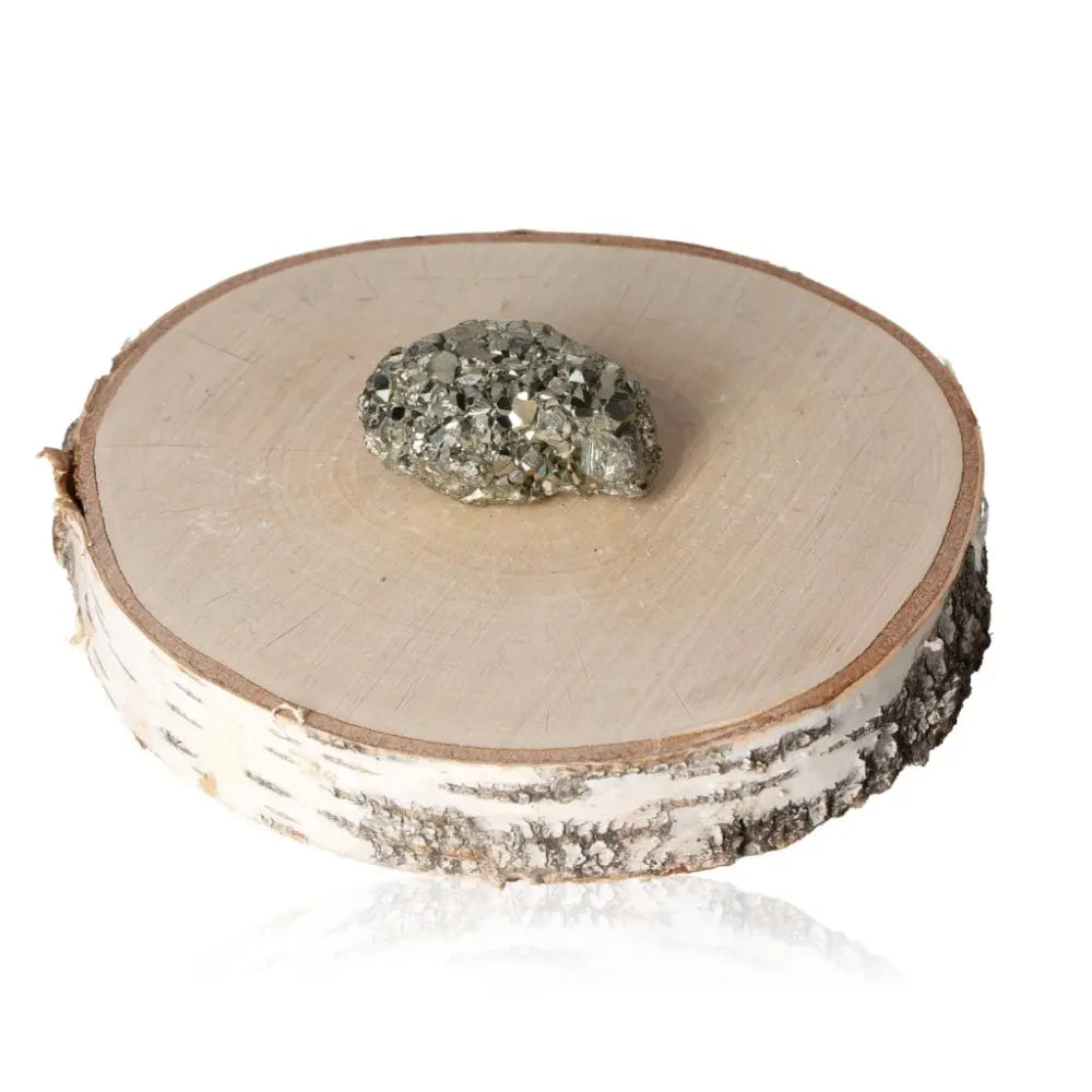 Pyrite druzy on a wooden display, showcasing its golden metallic luster and natural beauty, symbolizing abundance and prosperity.