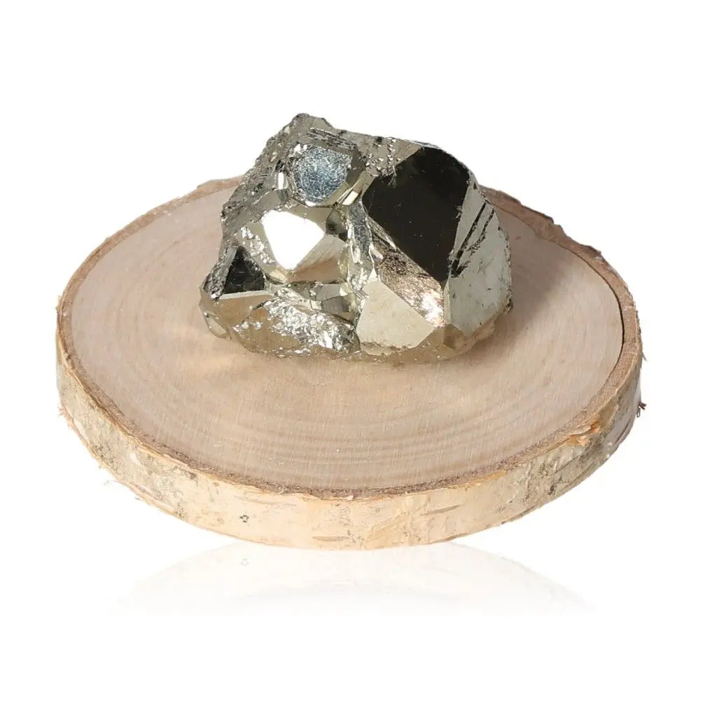 Pyrite druzy displayed on a wooden slice, showcasing its radiant golden hue and metallic luster; a stone symbolizing prosperity.