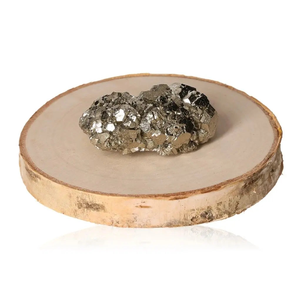Pyrite druze with golden metallic luster displayed on wooden stand, symbolizing abundance and prosperity in mineral collections.