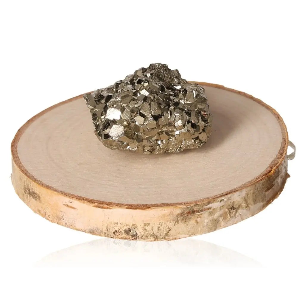 Pyrite druze displaying its radiant golden hue and metallic luster, symbolizing abundance and prosperity, on a wooden slice.
