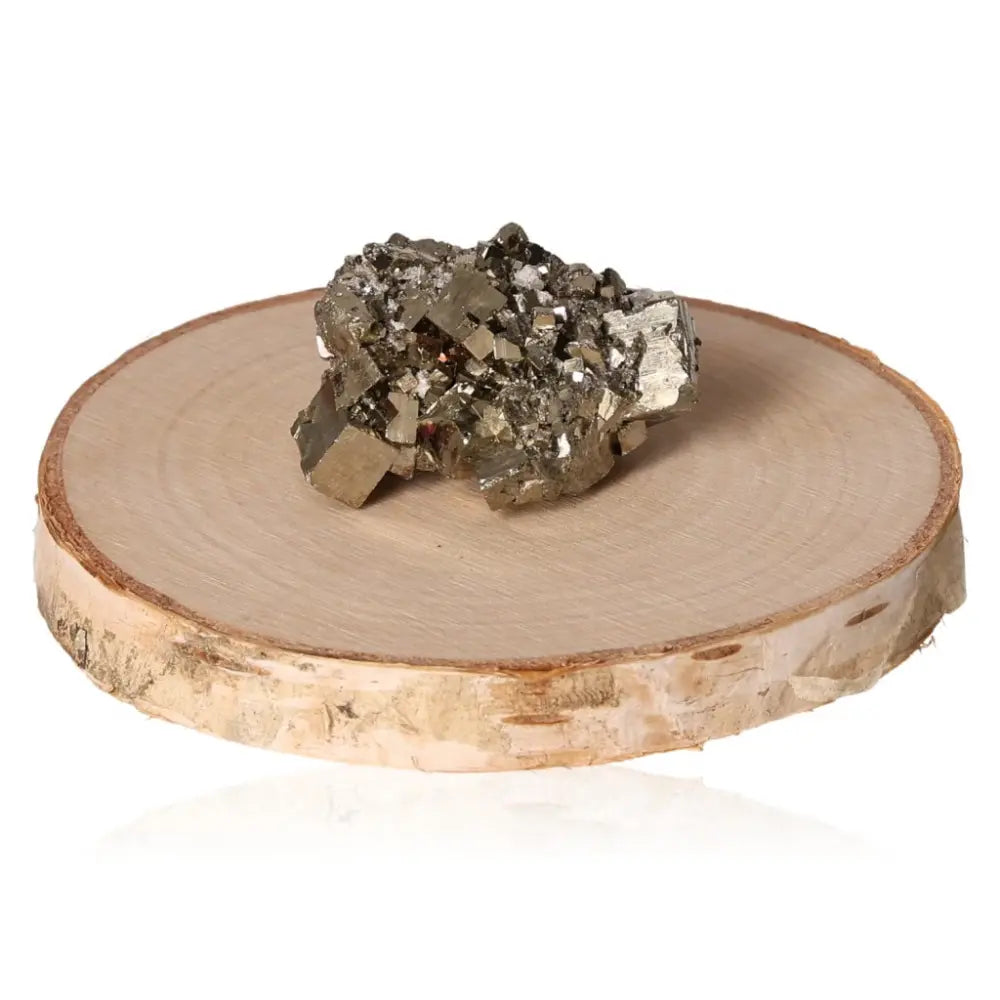 Pyrite druzy with metallic luster on a wooden stand, symbolizing abundance and prosperity, known as 'Fool's Gold.'