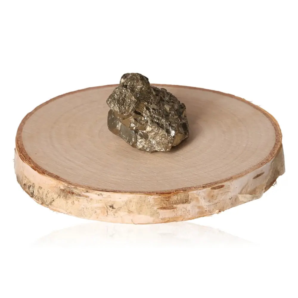 Pyrite druzy with golden hue on wooden display, showcasing its metallic luster and symbolic properties of wealth and success.