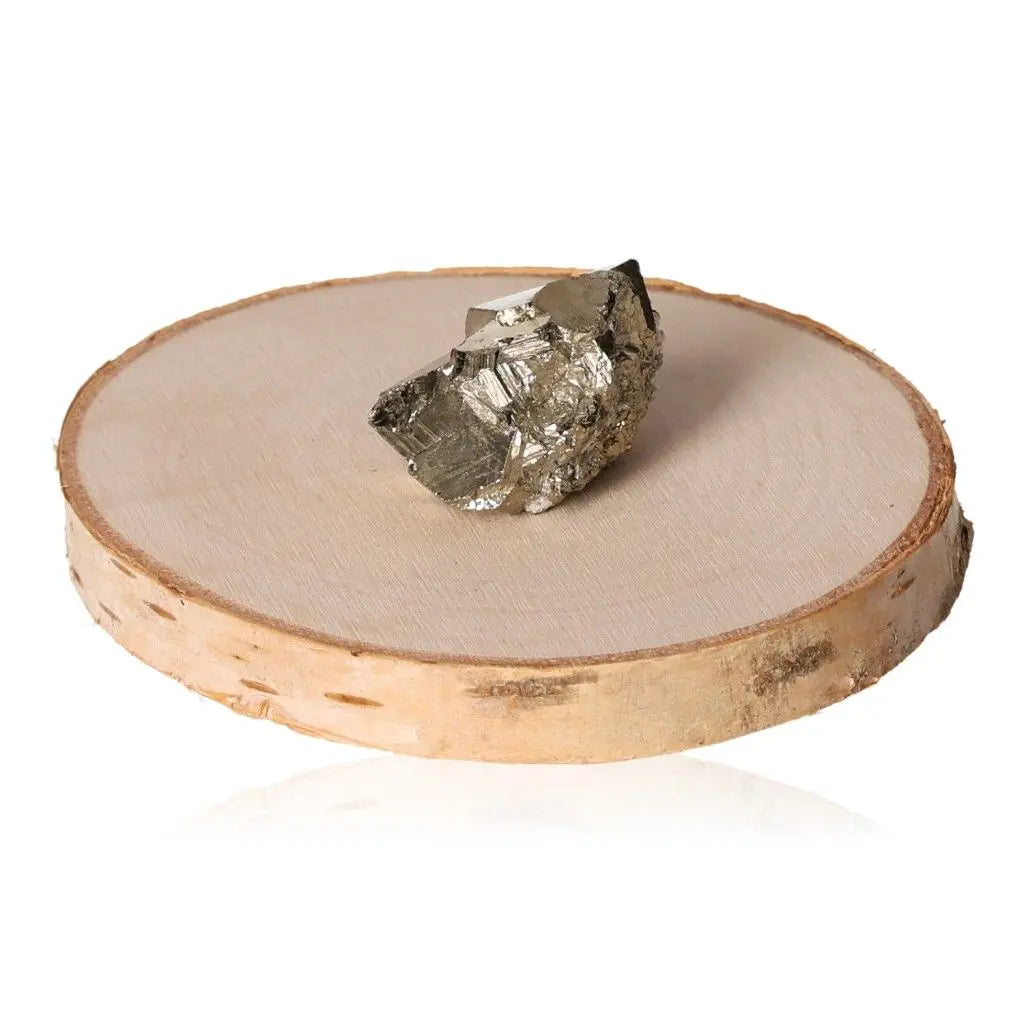 Pyrite druze crystal with golden hue and metallic luster displayed on a round wooden base, symbolizing wealth and prosperity.