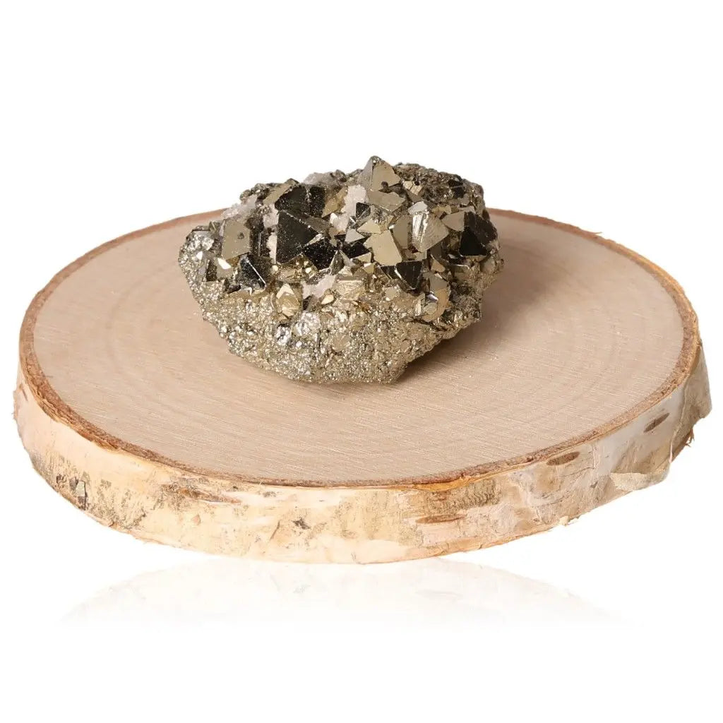Pyrite druzy stone with golden hue and metallic luster on a wooden base, symbolizing abundance and prosperity.