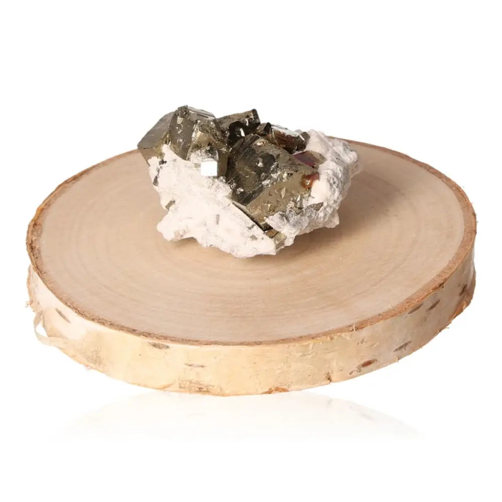 Pyrite druze mineral on a wooden base, showcasing its golden hue and metallic luster, symbolizing abundance and prosperity.
