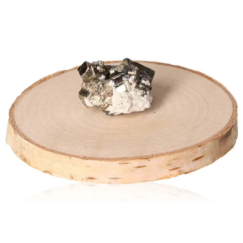 Pyrite druzy with gold metallic luster on circular wood slice, symbolizing abundance and prosperity. "Fool's Gold" mineral display.