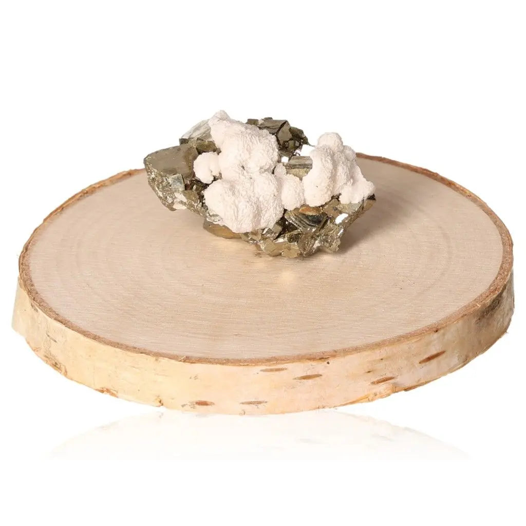 Pyrite druzy stone on wooden display, showcasing metallic luster and golden hue, symbolizing abundance and prosperity.