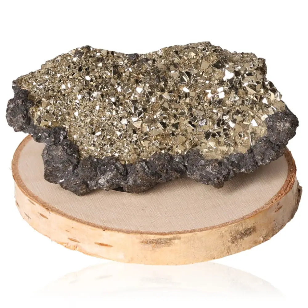 Pyrite druzy with golden hue on wooden base, known for its abundance and prosperity symbolism.