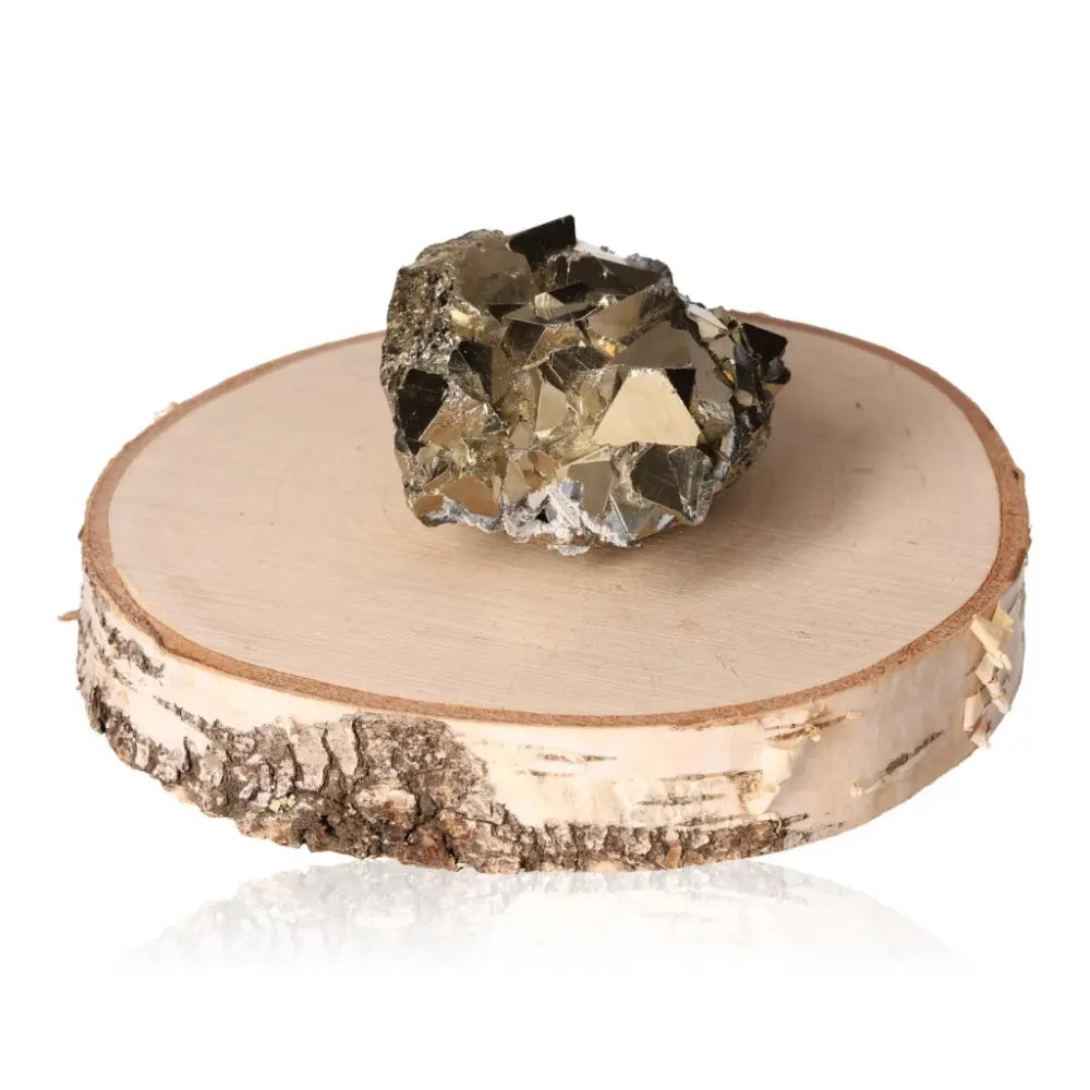 Pyrite druze crystal on wooden slab, showcasing its metallic luster and golden hue, symbolizing abundance and prosperity.