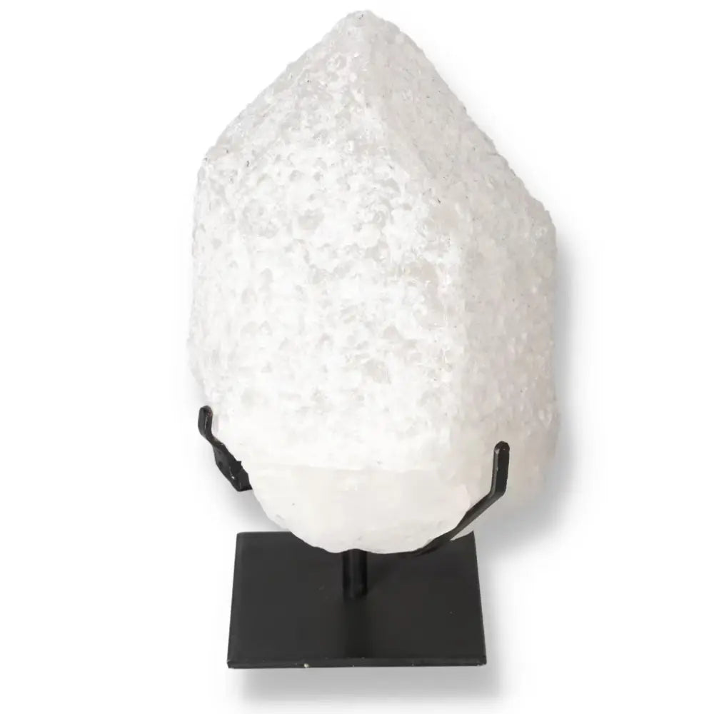 Quartz Crystal Bubble by Sylvia Crystals on black stand, showcasing its multifaceted structure and spiritual benefits.