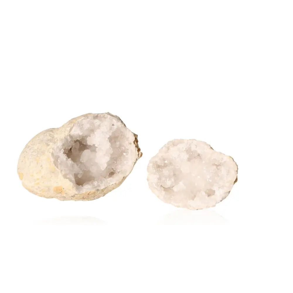 Open quartz geode showcasing sparkling milky quartz crystals, highlighting its rugged shell and cloudy white brilliance.