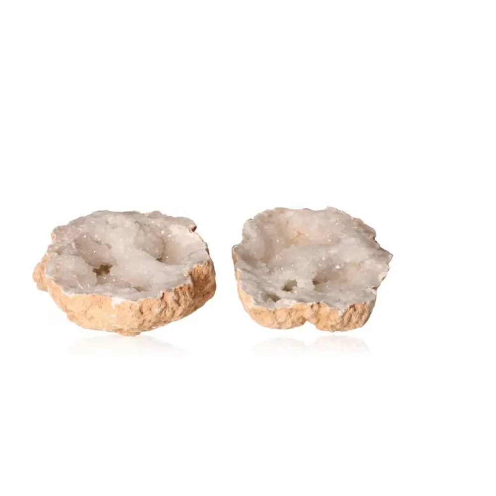 Quartz geode split open to reveal sparkling milky white crystals, showcasing natural beauty and metaphysical allure.