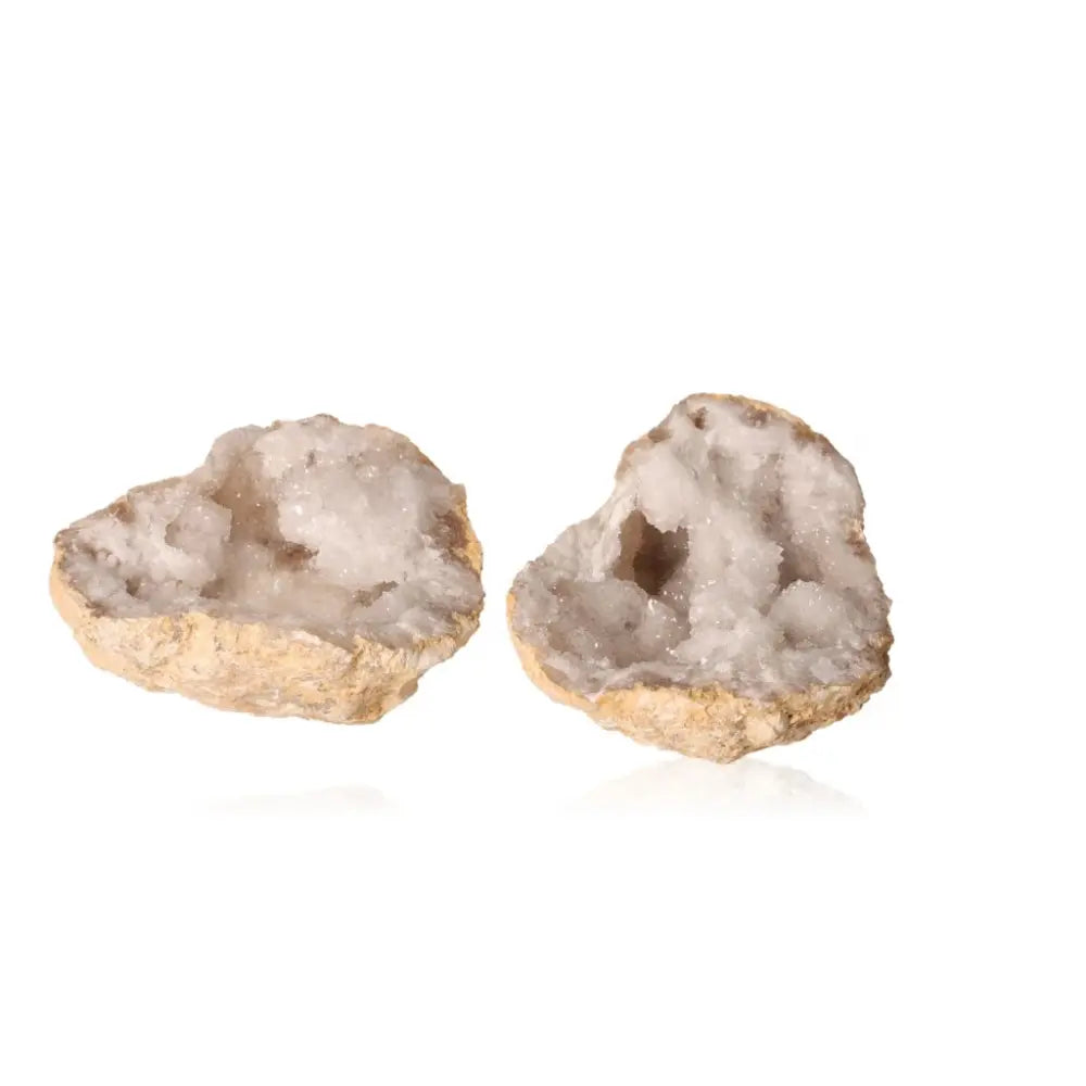 Quartz geode cracked open, revealing sparkling white crystals; a stunning blend of rugged exterior and serene interior beauty.