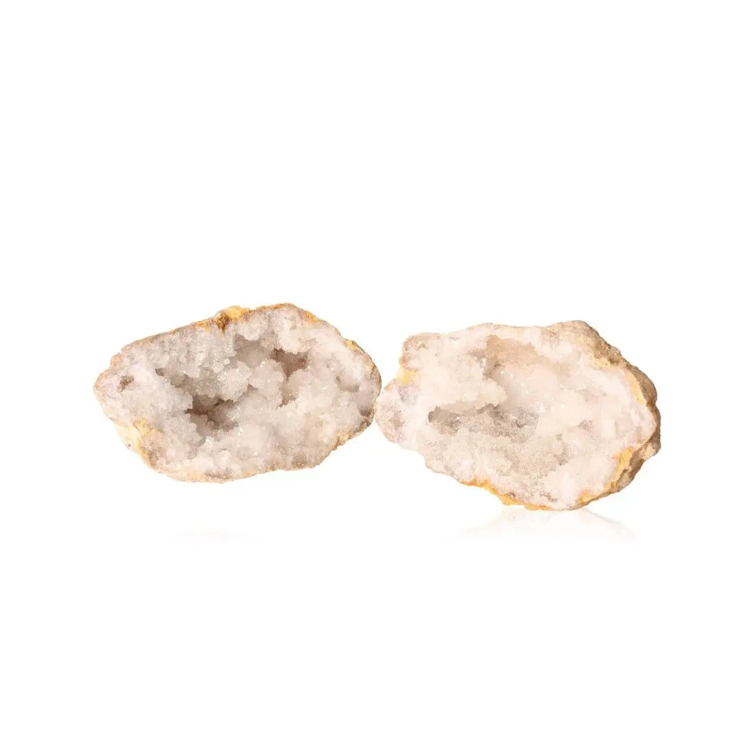 Quartz Geode showcasing its textured exterior and shimmering interior of cloudy white crystals, ideal for adding elegance and tranquility to any space.