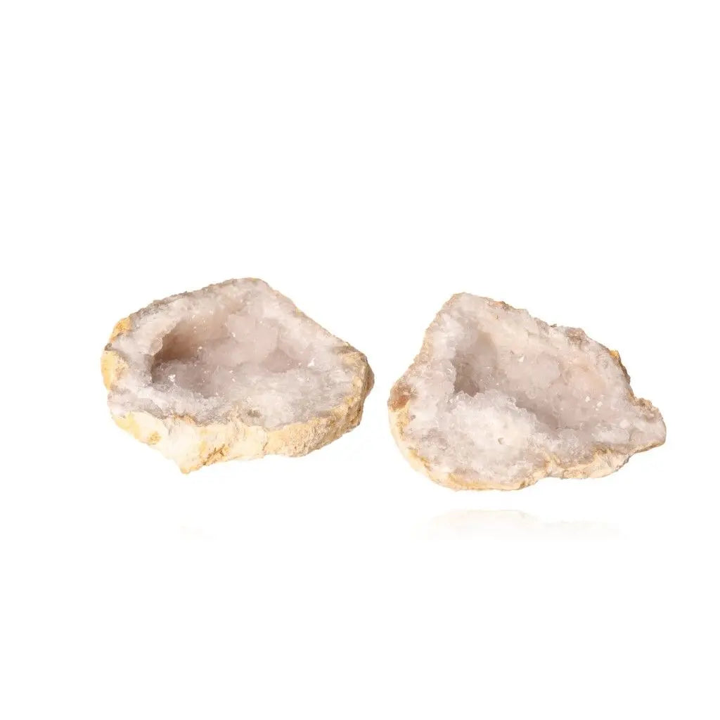 Quartz geode split open showcasing sparkling white crystals, highlighting its purity and energy amplification properties.