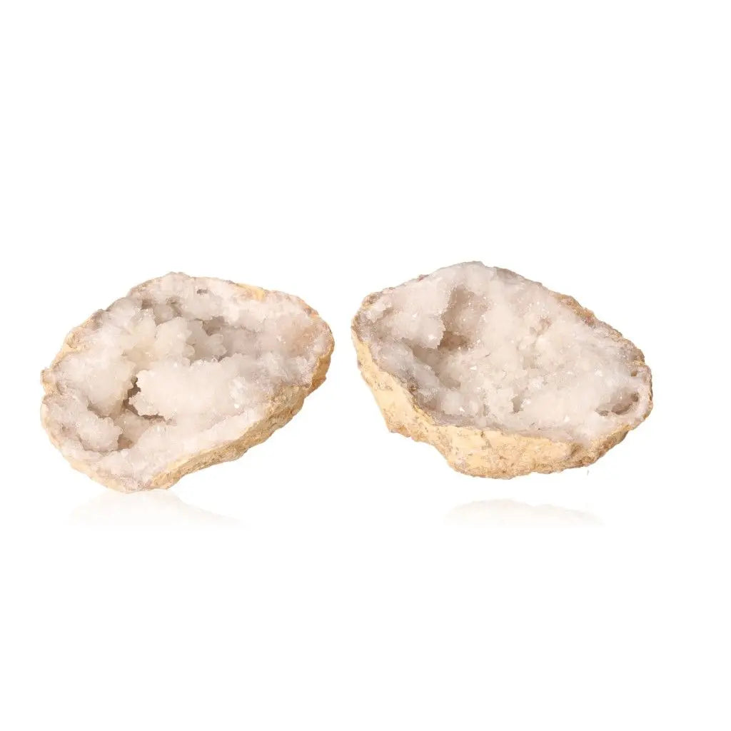 Open Quartz Geode displaying milky white crystals against a white background, highlighting its rugged exterior and sparkling interior.