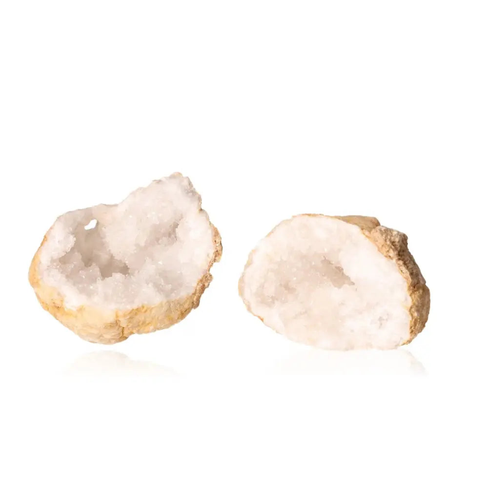 Quartz geode halves revealing milky quartz crystals, weighing 900-1200g. Decorative piece promoting tranquility and clarity.