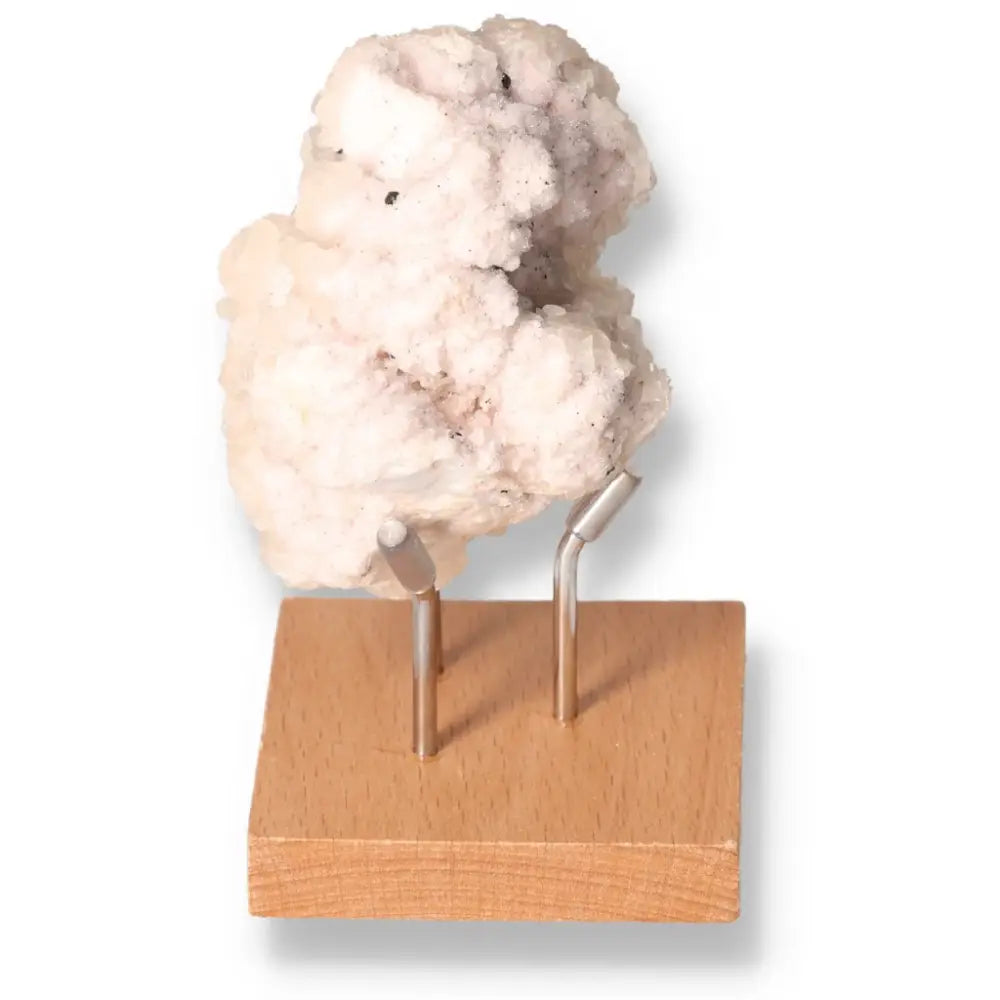 Quartz with Pink Halite on display stand offering energetic properties and spiritual harmony.