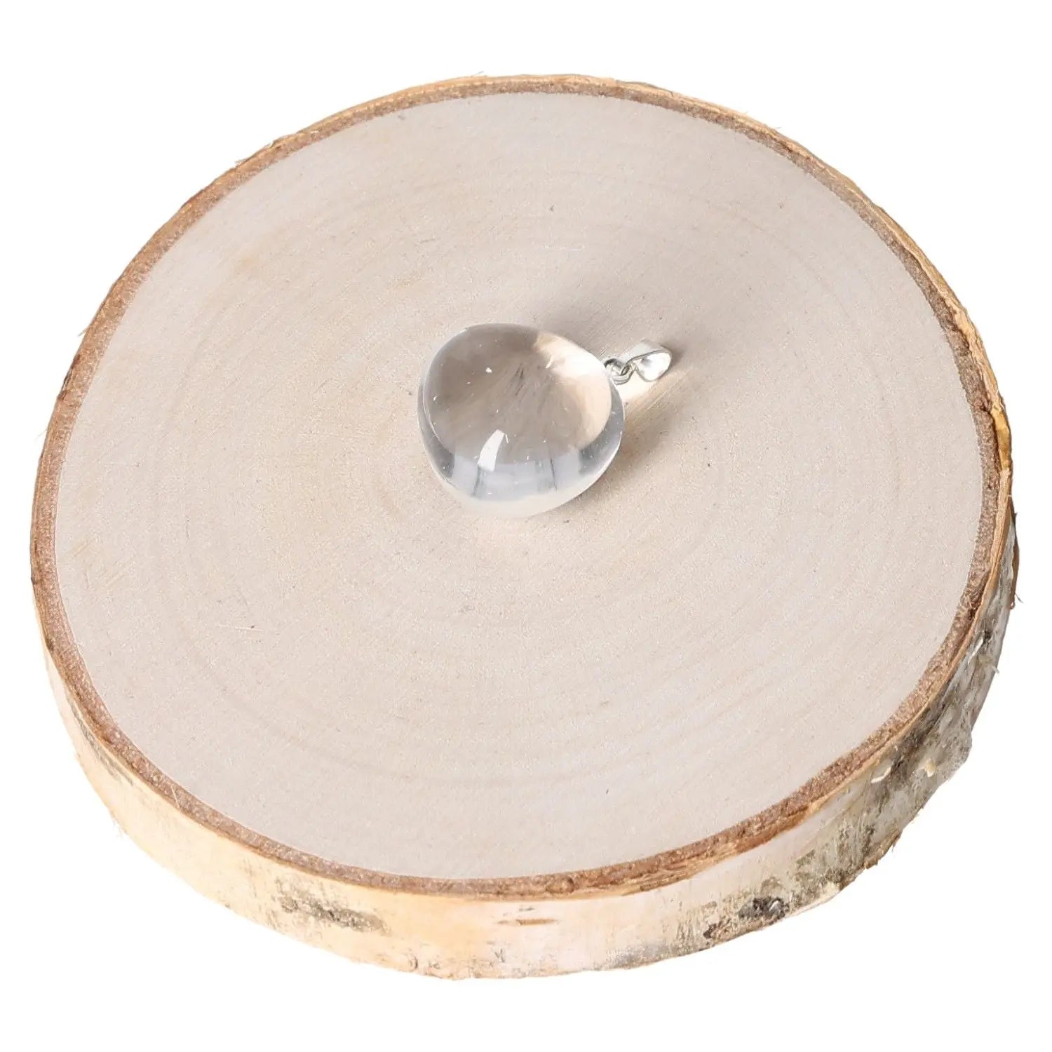 Rock Crystal AA Tumbled Pendant displayed on wooden dish, showcasing natural elegance and timeless beauty.