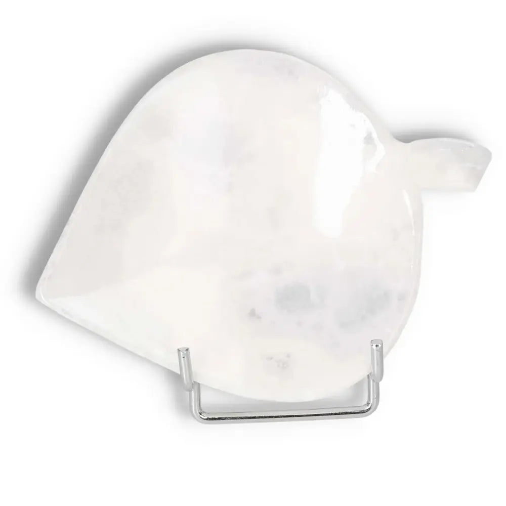 White onyx leaf platter with polished finish on a stand, showcasing unique natural veining and a smooth, glossy surface for elegant dining.