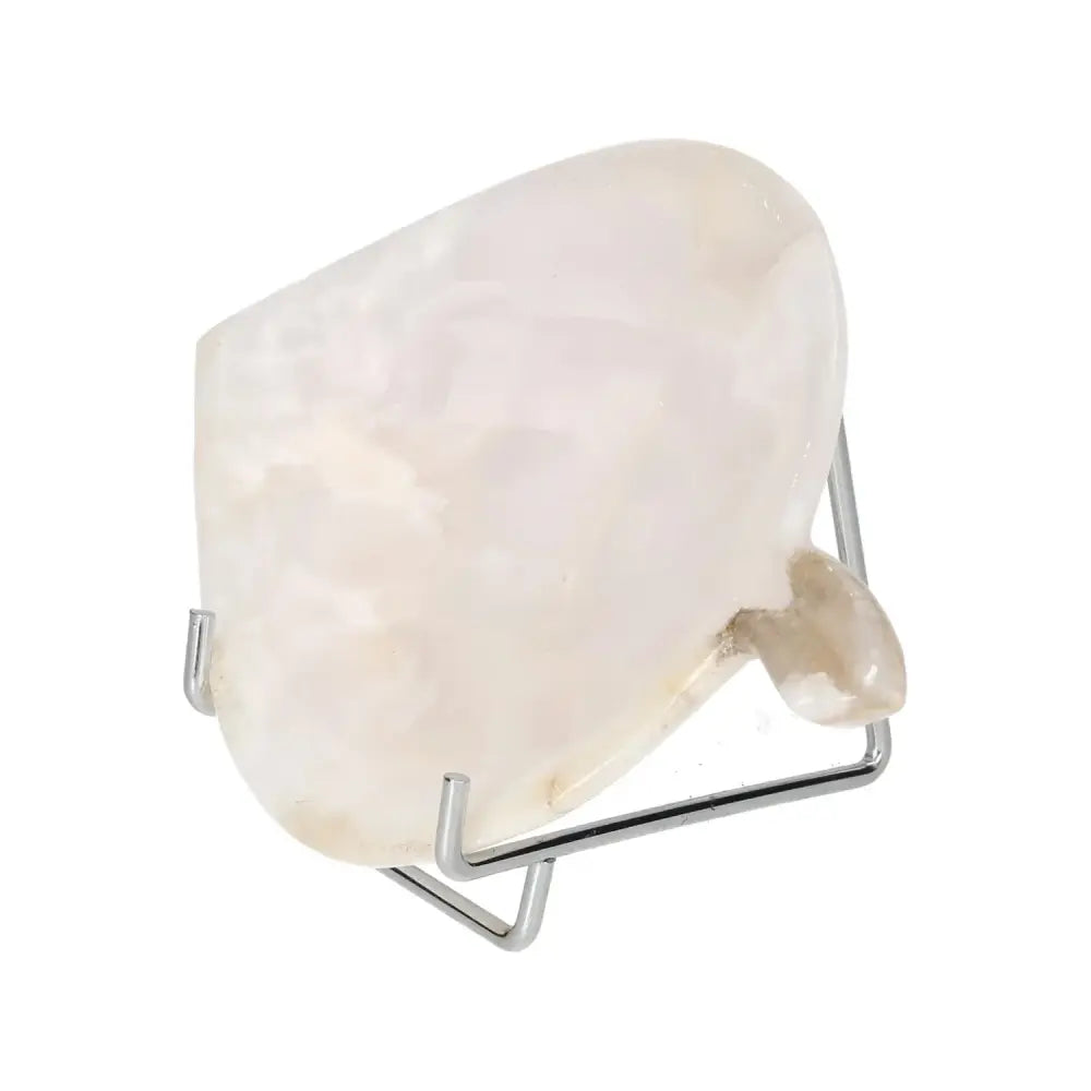 Rose onyx platter with unique veining on a metal stand, showcasing elegance and natural beauty.