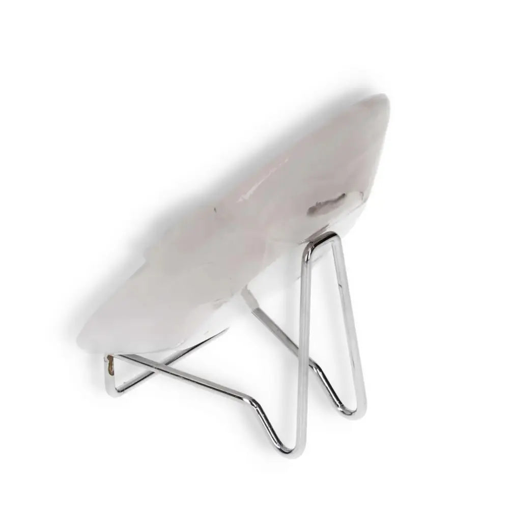 Rose onyx platter displayed on a stand, showcasing unique pink veining and a polished surface, ideal for elegant table settings.