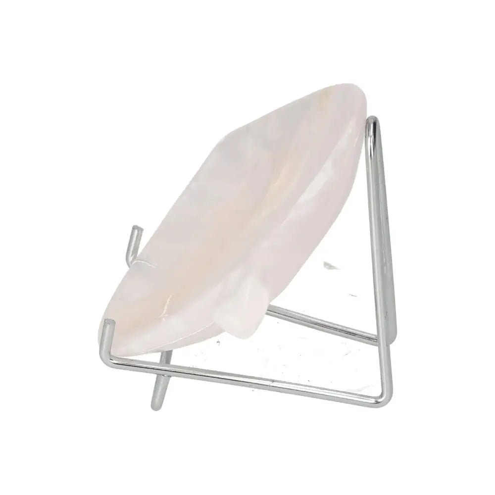 Rose onyx platter displayed on a stand, showcasing its elegant rose-hued finish and unique veining pattern.