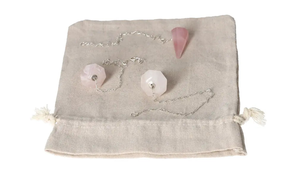 Rose Quartz Pendulum on fabric pouch, symbolizing love, healing, and emotional balance. Ideal for enhancing relationships and empathy.