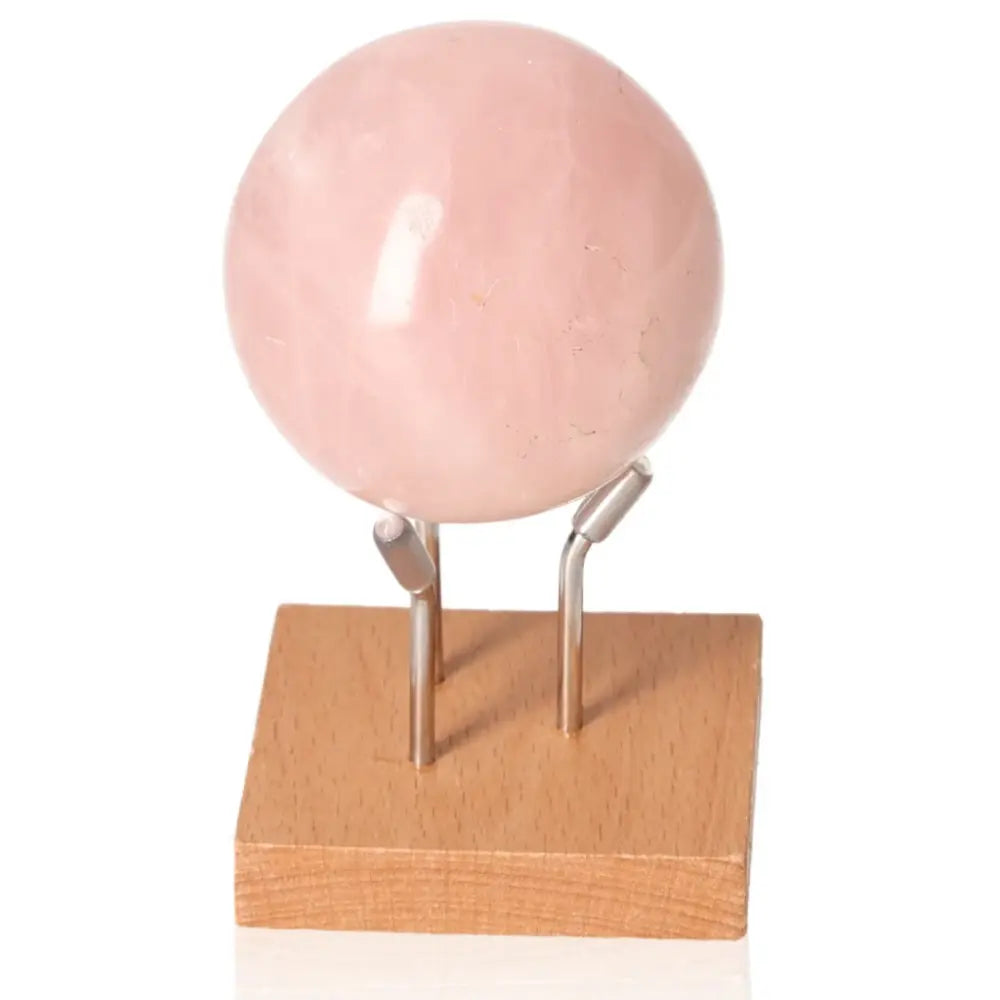 Rose Quartz Sphere on stand from Sylvia Crystals, symbolizing love and peace, crafted from natural, ethically sourced materials.