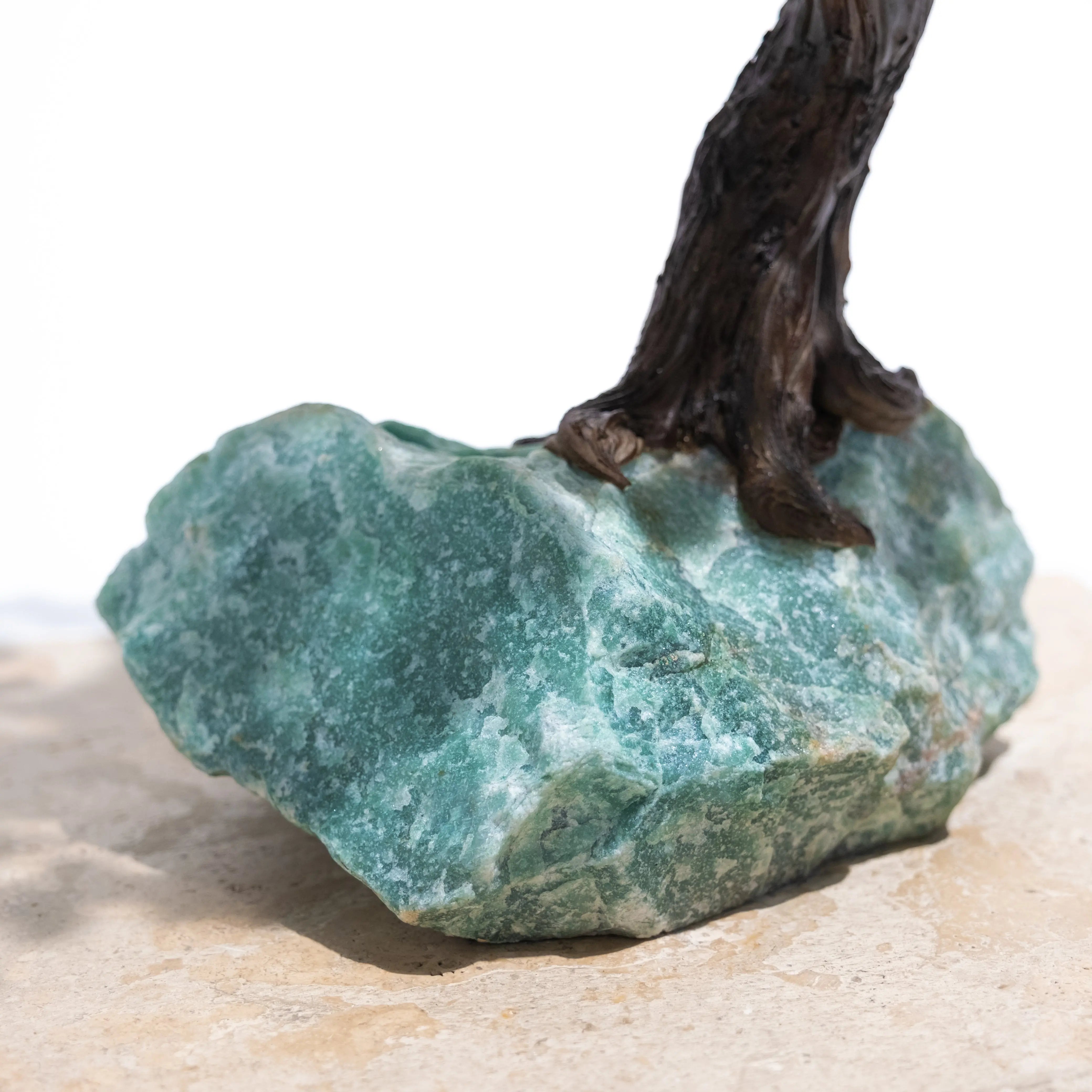 Close-up of green Aventurine Crystal base of a handcrafted bonsai tree.
