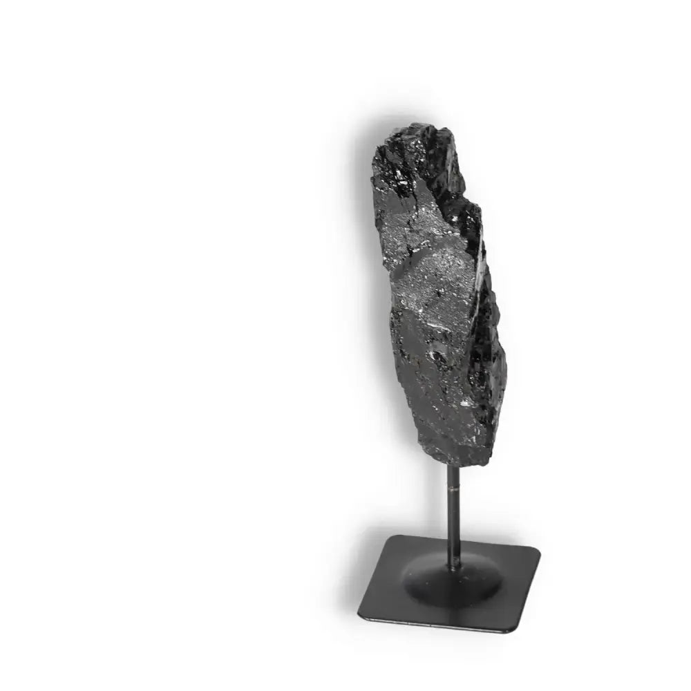 Rough Black Tourmaline on metal stand from Sylvia Crystals, a premium crystal known for cleansing negative energies.