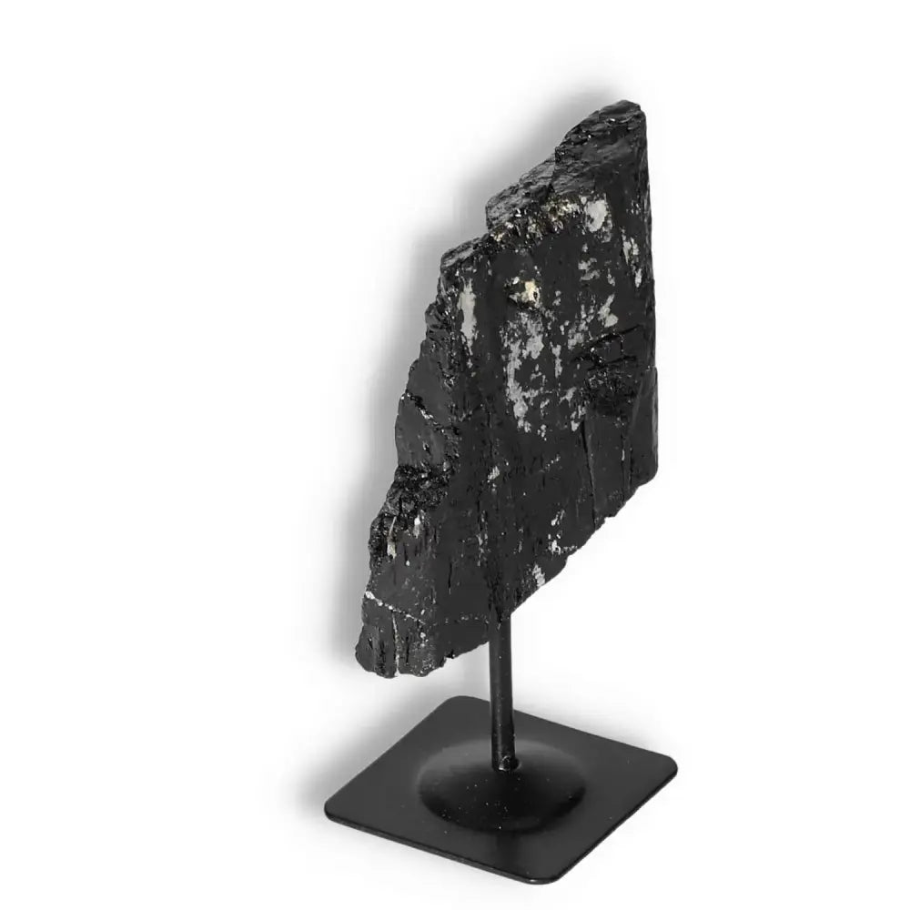 Rough Black Tourmaline on metal stand, premium quality by Sylvia Crystals, known for cleansing energy and neutralizing negative forces.