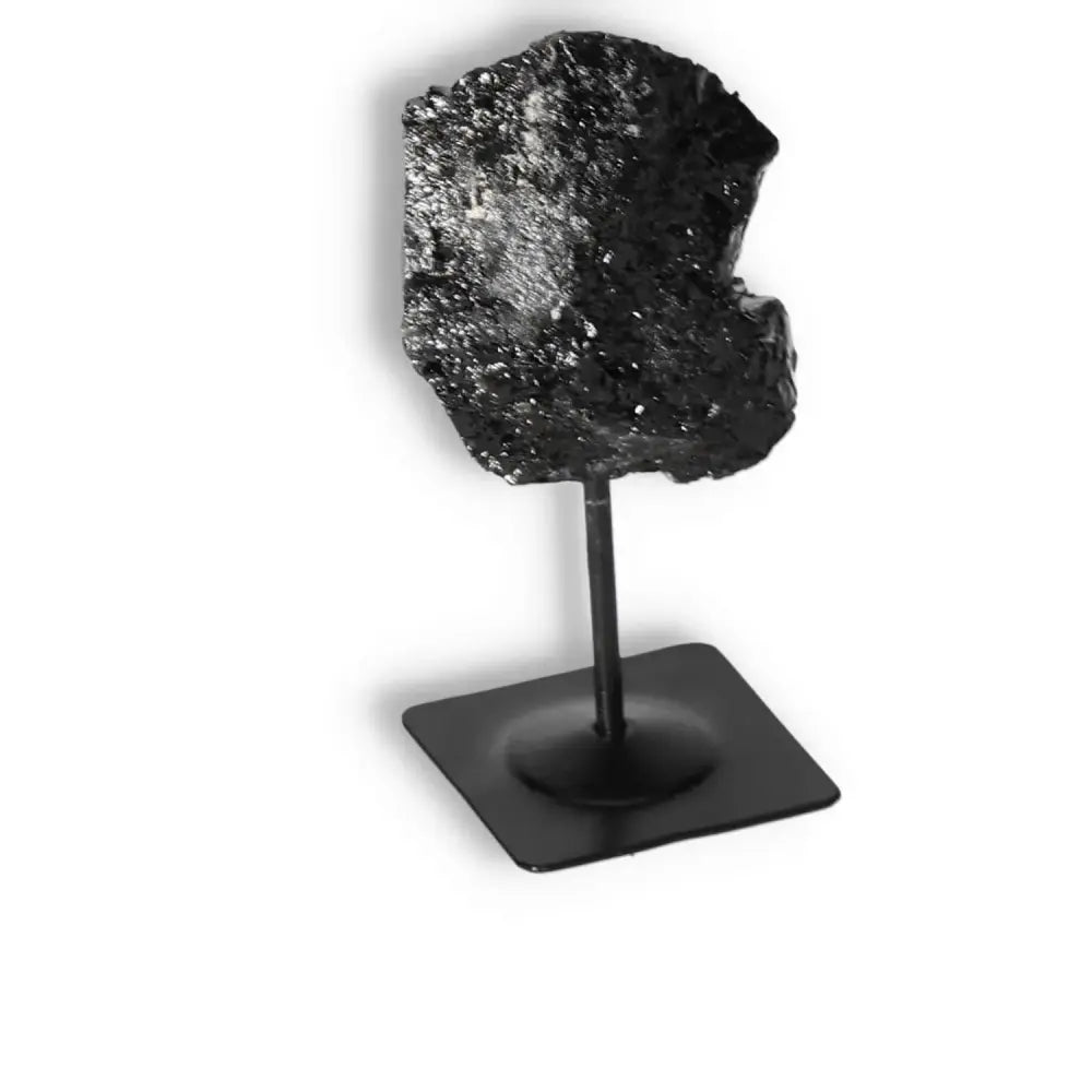 Rough Black Tourmaline on Metal Stand M, featuring luxury and cleansing energy, from Sylvia Crystals.