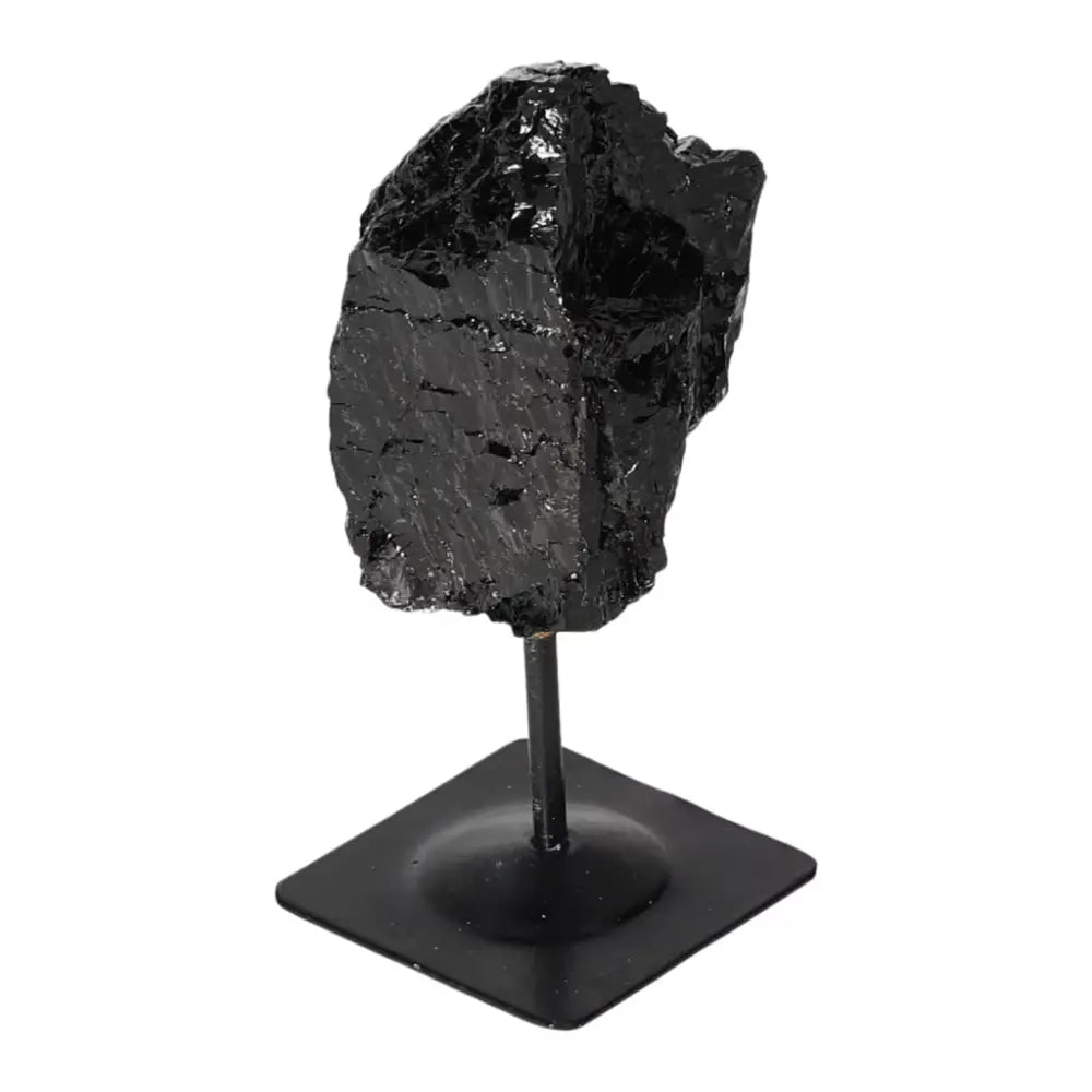 Handpicked rough black tourmaline on metal stand, transforms negative energies, available at Sylvia Crystals.