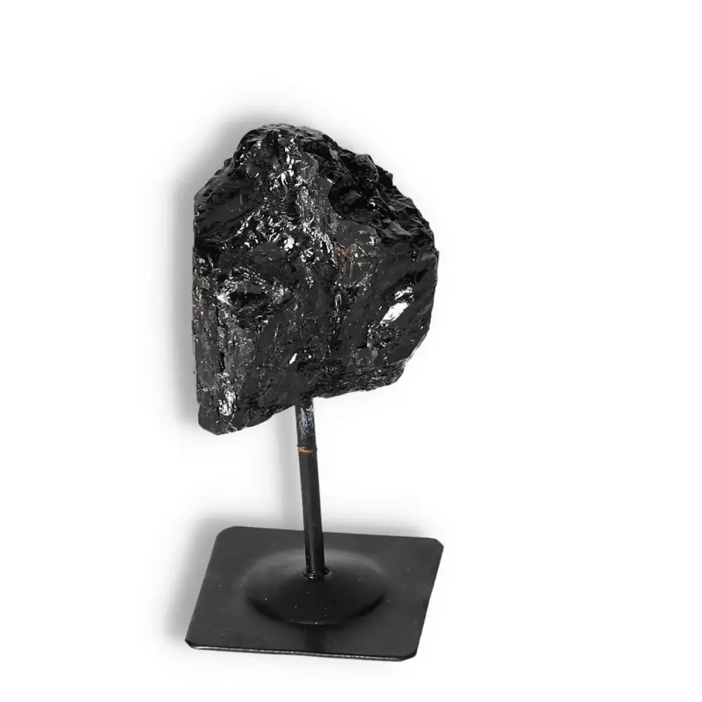 Rough Black Tourmaline Crystal on Stand from Sylvia Crystals, known for transformative and cleansing properties against negative energy.