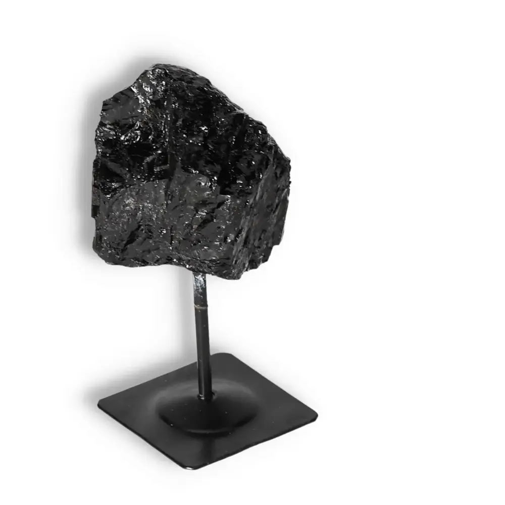 Rough Black Tourmaline with Metal Stand S for cleansing negative energies, offered by Sylvia Crystals.