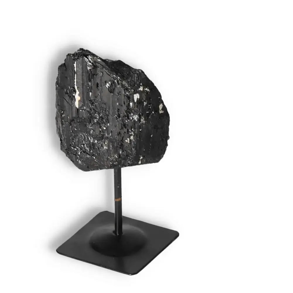 Rough Black Tourmaline on metal stand S, offering luxury and spiritual connection, from Sylvia Crystals.