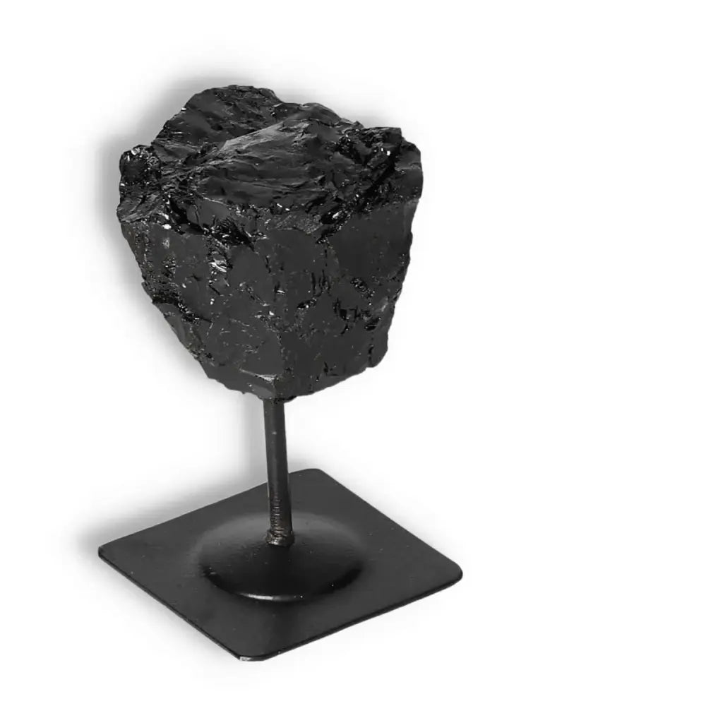 Rough Black Tourmaline on metal stand from Sylvia Crystals for cleansing negative energies.