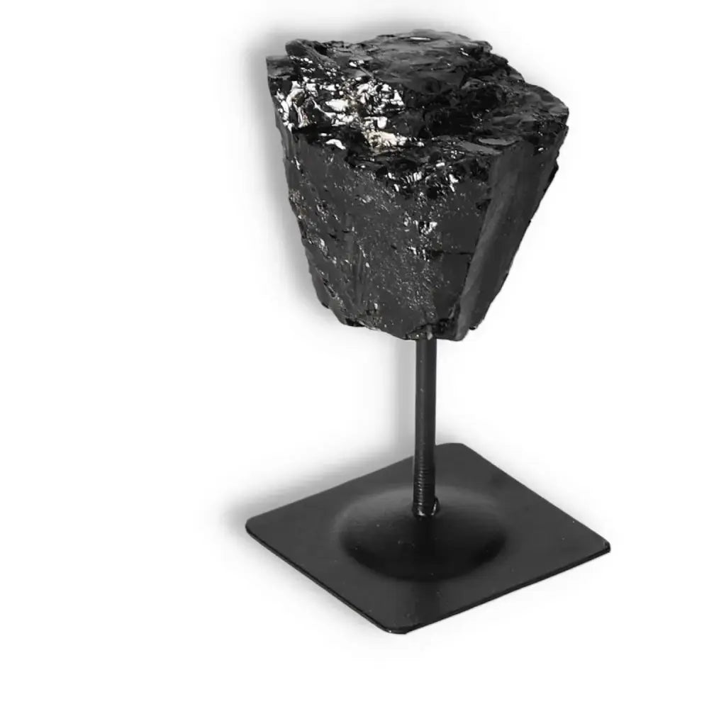 Rough Black Tourmaline on metal stand, premium crystal for healing and energy cleansing by Sylvia Crystals.