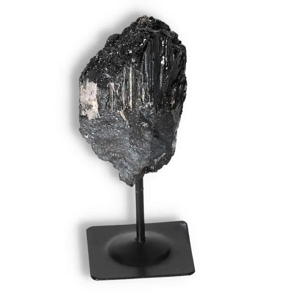 Rough Black Tourmaline with Metal Stand by Sylvia Crystals, showcasing luxury and spiritual balance for a harmonious environment.