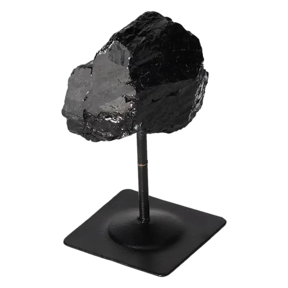 Rough Black Tourmaline with metal stand, part of Sylvia Crystals collection, known for cleansing negative energies; luxury home decor.