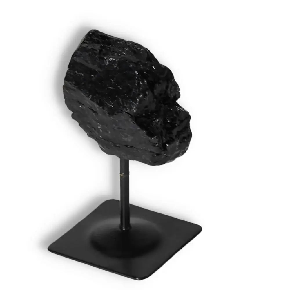 Rough Black Tourmaline with Metal Stand S from Sylvia Crystals, known for cleansing and transforming negative energies.