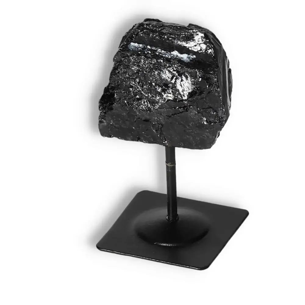 Rough Black Tourmaline on Metal Stand, premium Sylvia Crystals decor, known for cleansing and transforming negative energies.