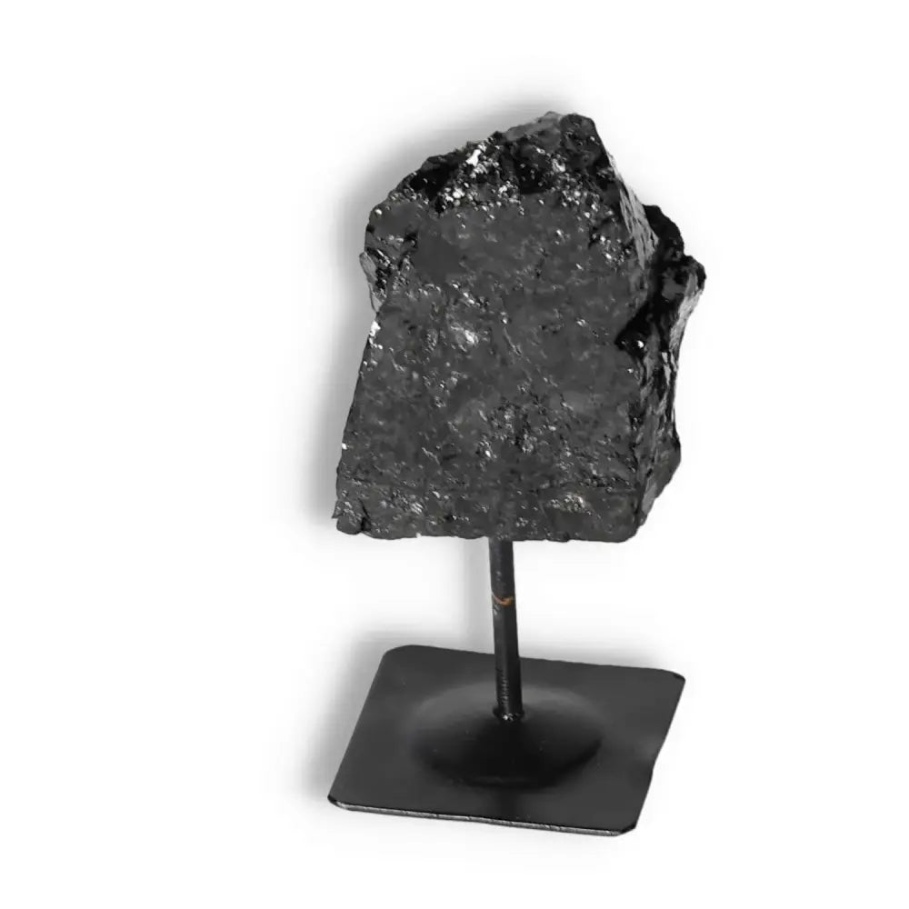 Rough Black Tourmaline on Metal Stand by Sylvia Crystals, enhances wellness by dispelling negative energies, elegant home decor piece.