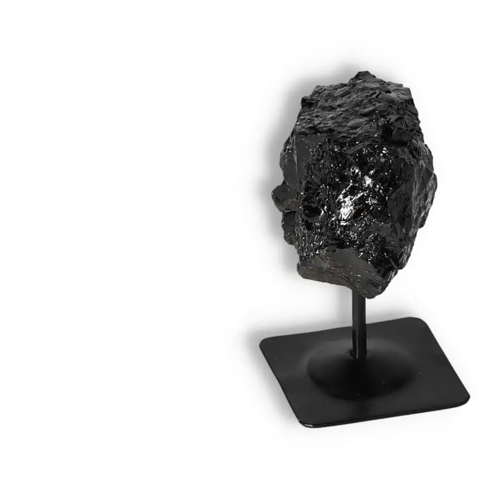 Rough Black Tourmaline on metal stand, offering spiritual energy cleansing, premium quality by Sylvia Crystals.