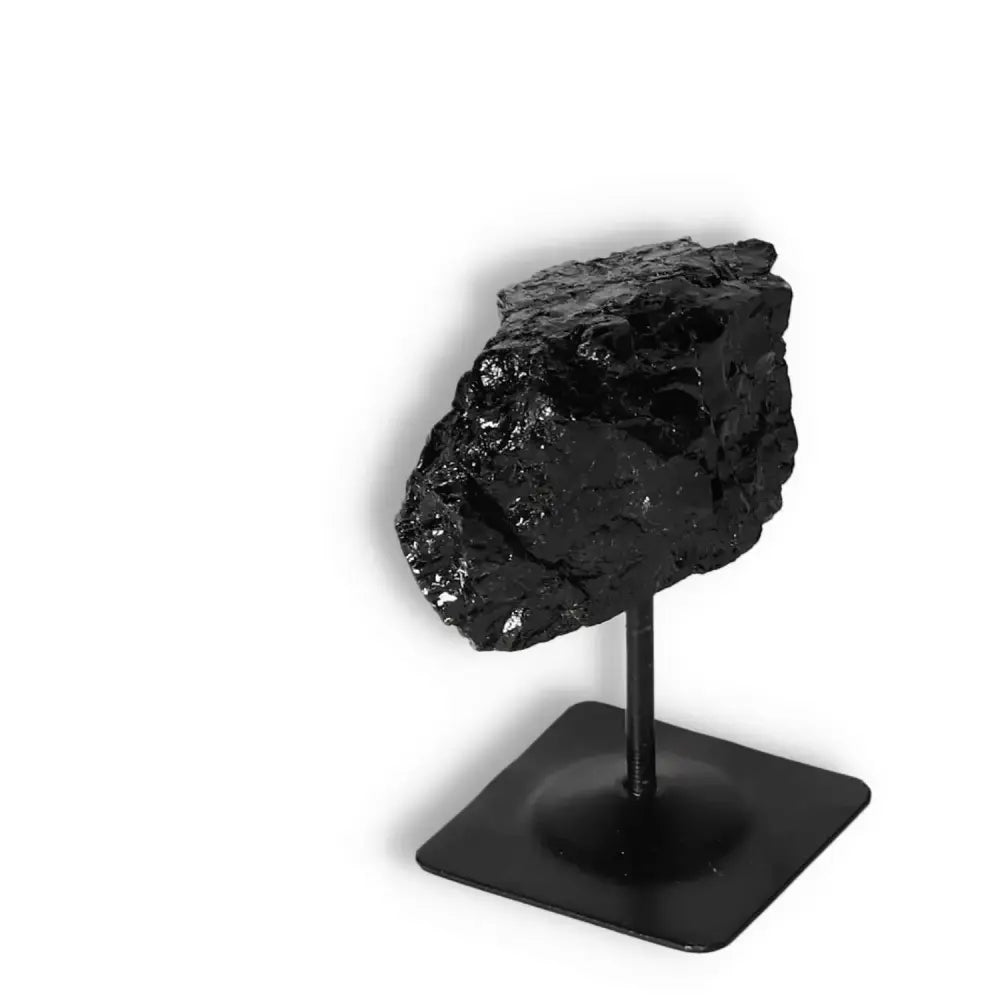 Rough Black Tourmaline on Metal Stand from Sylvia Crystals, perfect for cleansing energy and enhancing home decor.